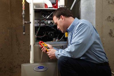 Man diagnosing broken air conditioning furnace with 10 troubleshooting tips