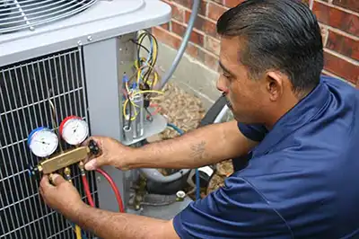 Extreme-Comfort HVAC technician conducting AC checkup to save money on air conditioning this summer