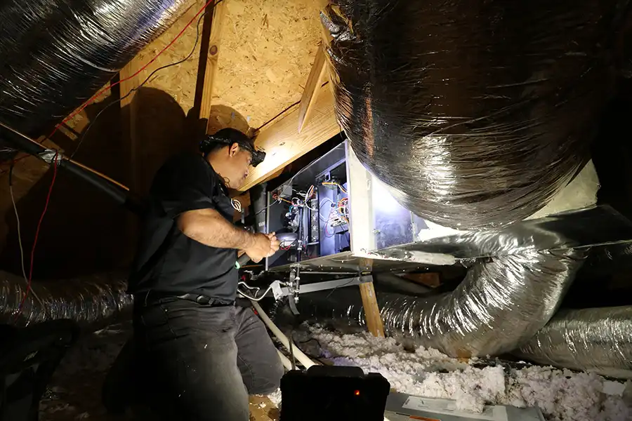 Air Conditioner Repair technician Tony in attic Air Conditioner Repair technician in attic for an ac repair service call in Dallas