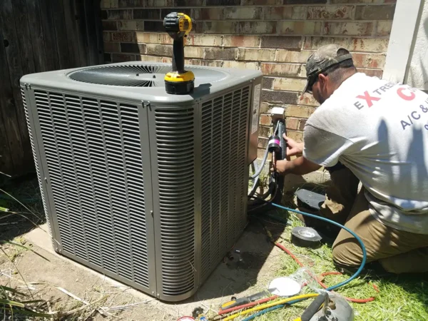 HVAC technician repairing outdoor AC unit in Allen Texas